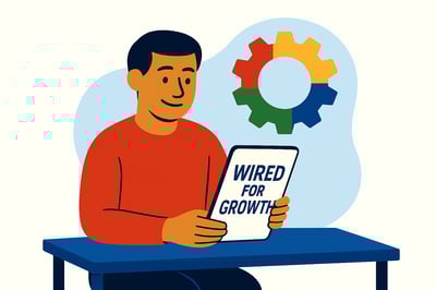A person sits at a blue table reviewing a document labeled “Wired for Growth.” They appear calm and focused. Behind them, a fully colored MyHardWired gear is mounted on the wall, with a soft blue abstract background shape framing the scene.