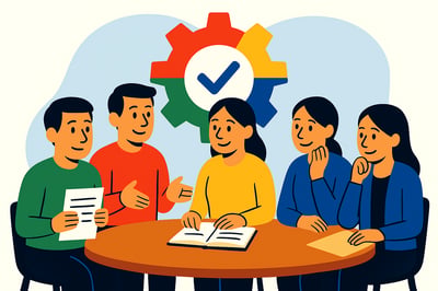 Four people wearing MyHardWired colors sit around a table discussing feedback, with a large multicolored MyHardWired gear behind them and an open notebook in the center representing insight and growth.