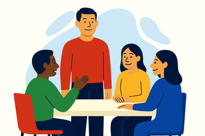 A calm, grounded leader stands confidently at the center of a small team discussion, while three colleagues sit around a table engaged and at ease. The scene reflects steady, authentic leadership rather than loud or forceful behavior.